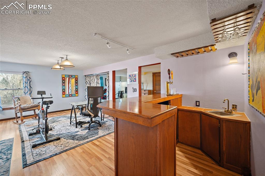 Image 24 of 32: Reverse view of bar & wet bar with built in kegerator system.