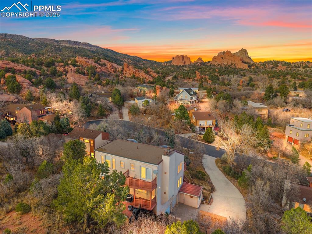 Image 32 of 32: Twilight enhanced rear shot of home looking east with a view of Garden of t