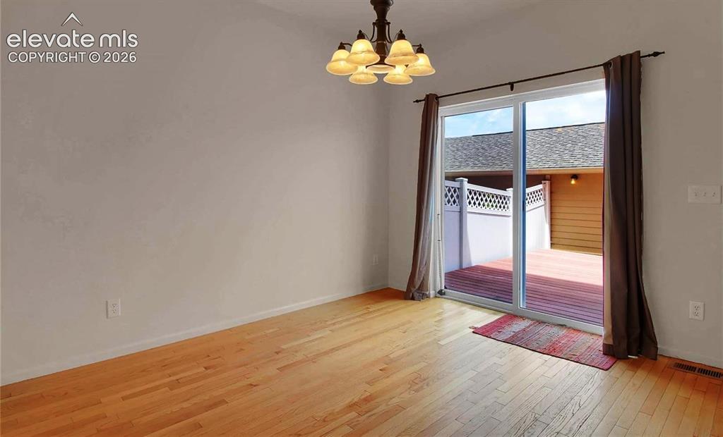 Image 9 of 24: When vacant dining area facing walkout slider