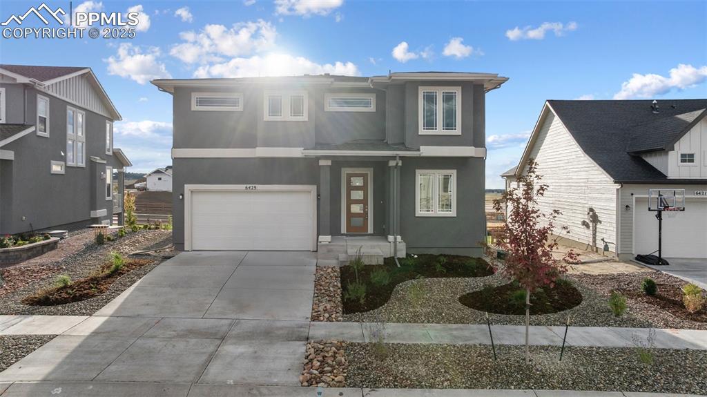 Image 4 of 41: Beautiful, low maintenance front yard and easy care stucco!