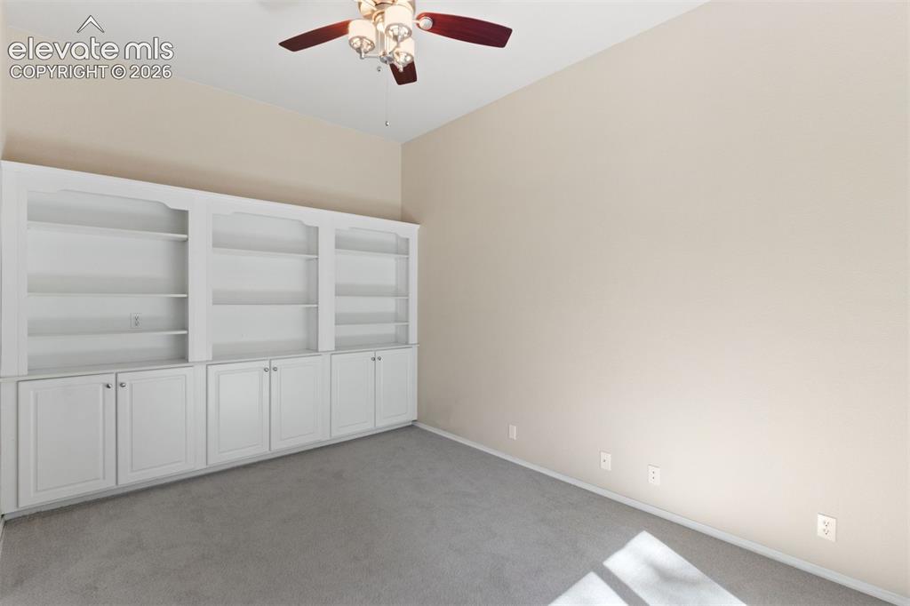 Image 20 of 50: Dedicated main level office with french doors and ceiling fan