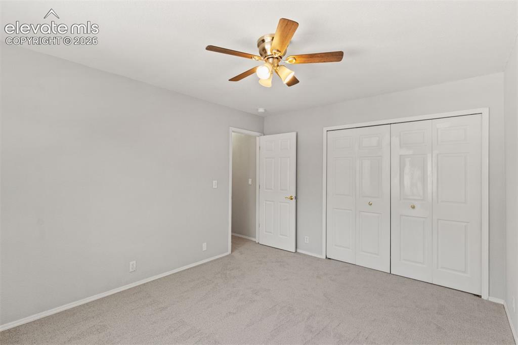 Image 31 of 50: Upstairs bedroom with ceiling fan