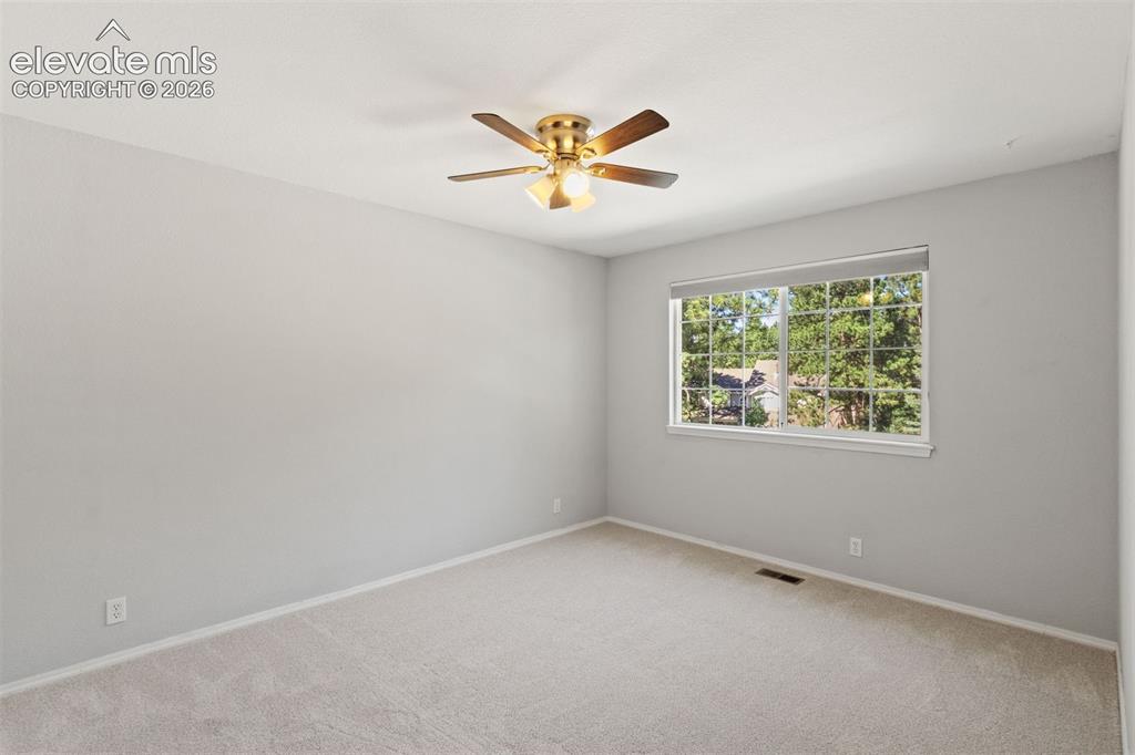 Image 32 of 50: Upstairs bedroom with ceiling fan