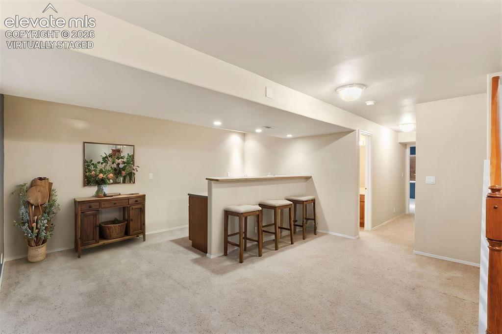 Image 35 of 50: *virtually staged* Basement wet bar