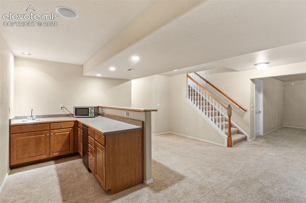 Image 39 of 50: Basement wet bar