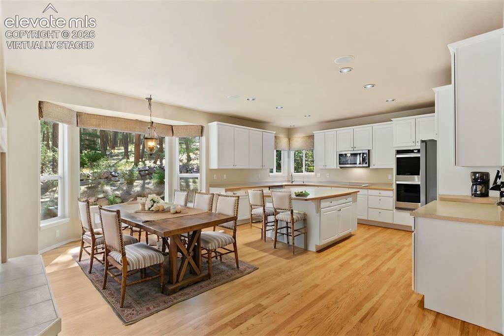 Image 4 of 50: *virtually staged* Dining area off kitchen, walkout access, large bay windo