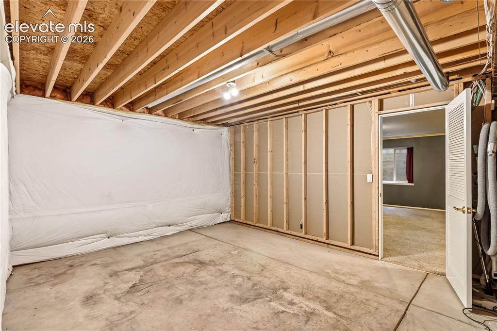 Image 48 of 50: unfinished storage space is perfect for a workshop
