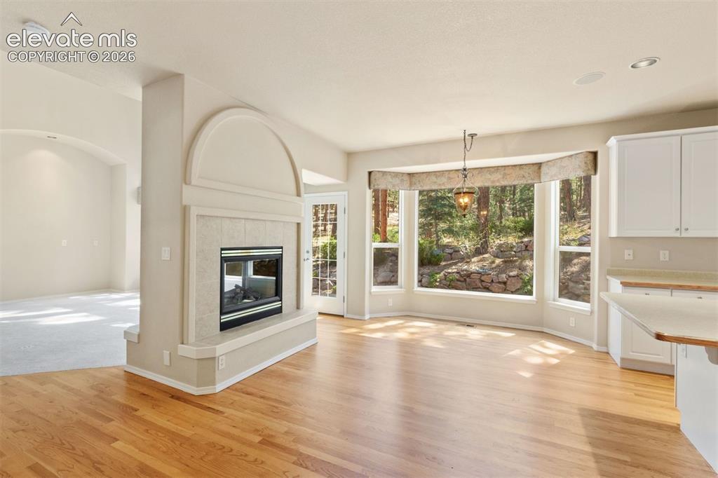 Image 8 of 50: Dining area off kitchen, walkout access, large bay window, dual sided forep
