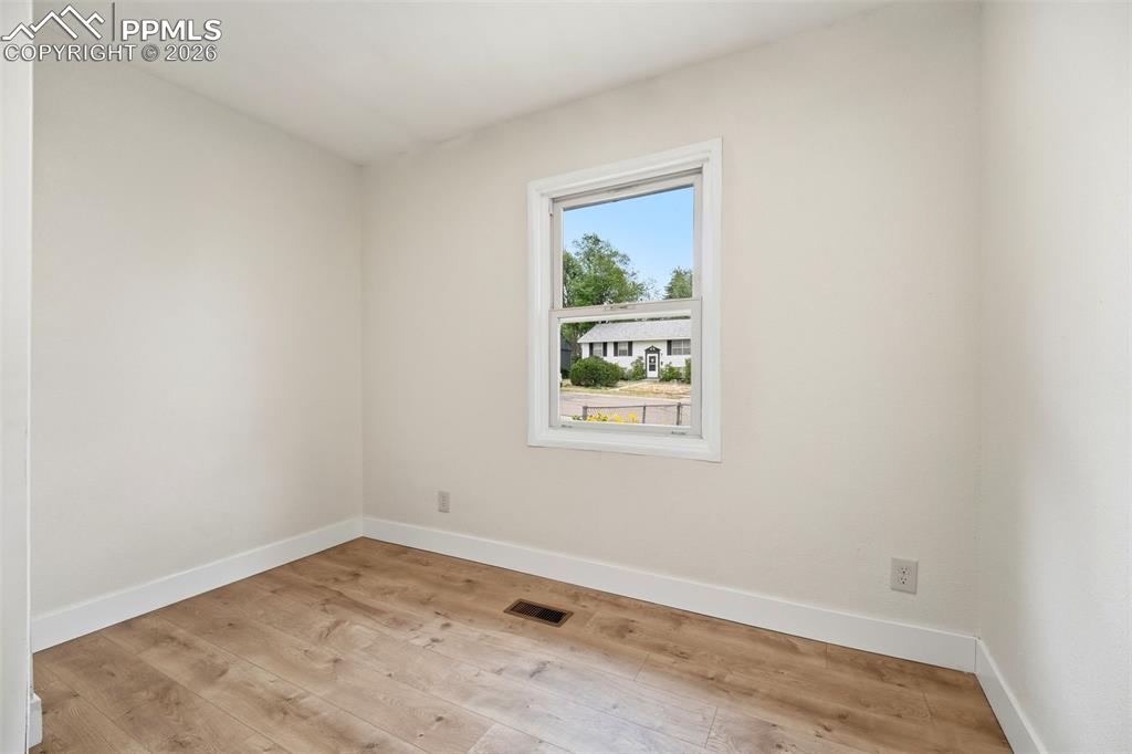 Image 10 of 38: Neutral wall tones with wood-finish flooring
