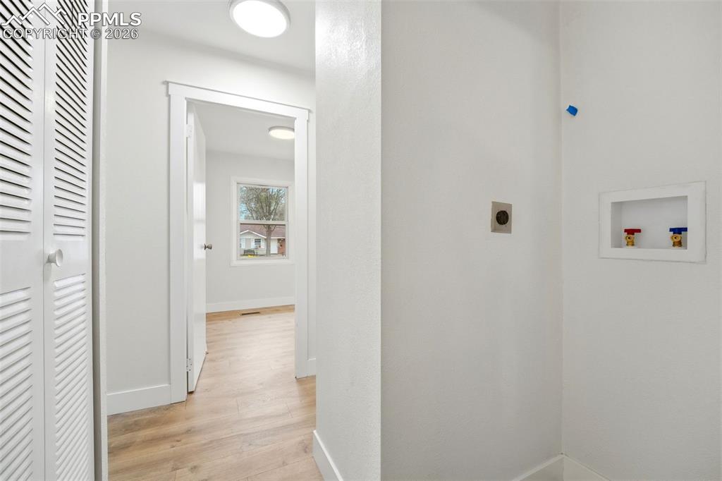 Image 13 of 38: Dedicated laundry area featuring a recessed hookup box and ventilation