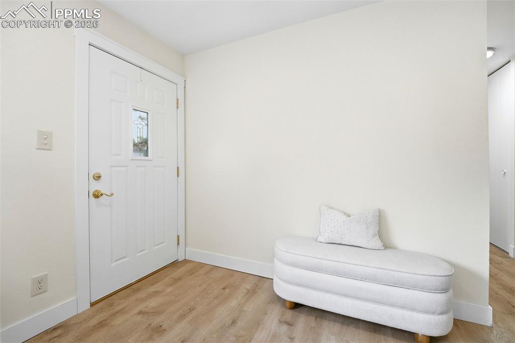 Image 2 of 38: Entryway featuring a paneled door with decorative glass, brass hardware, an
