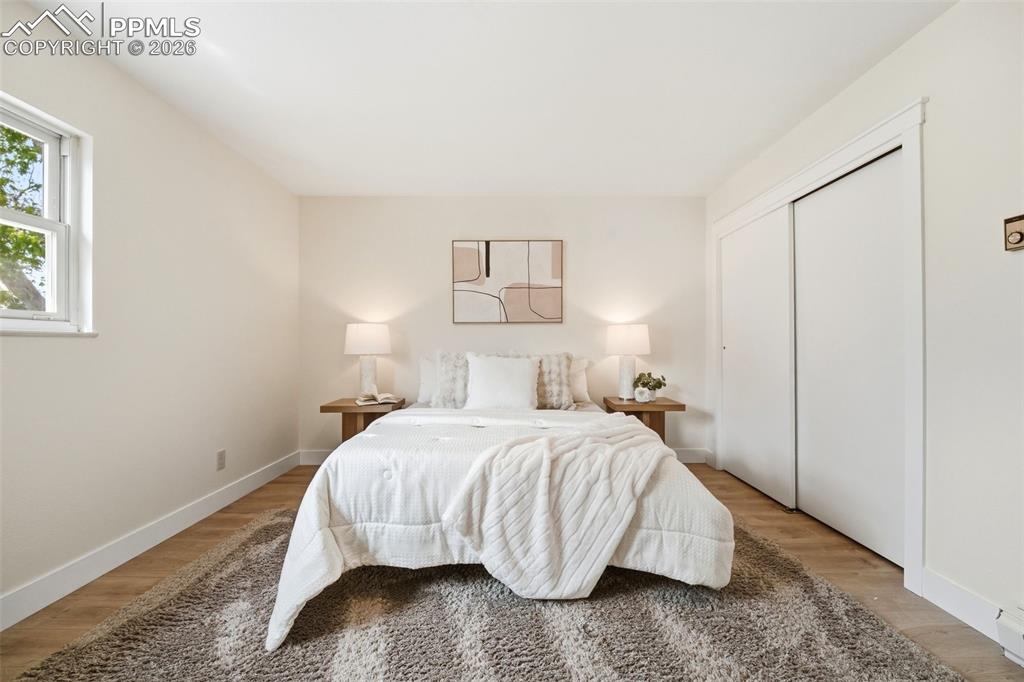 Image 20 of 38: Light-filled room featuring wood-finish flooring, a double-pane window, and