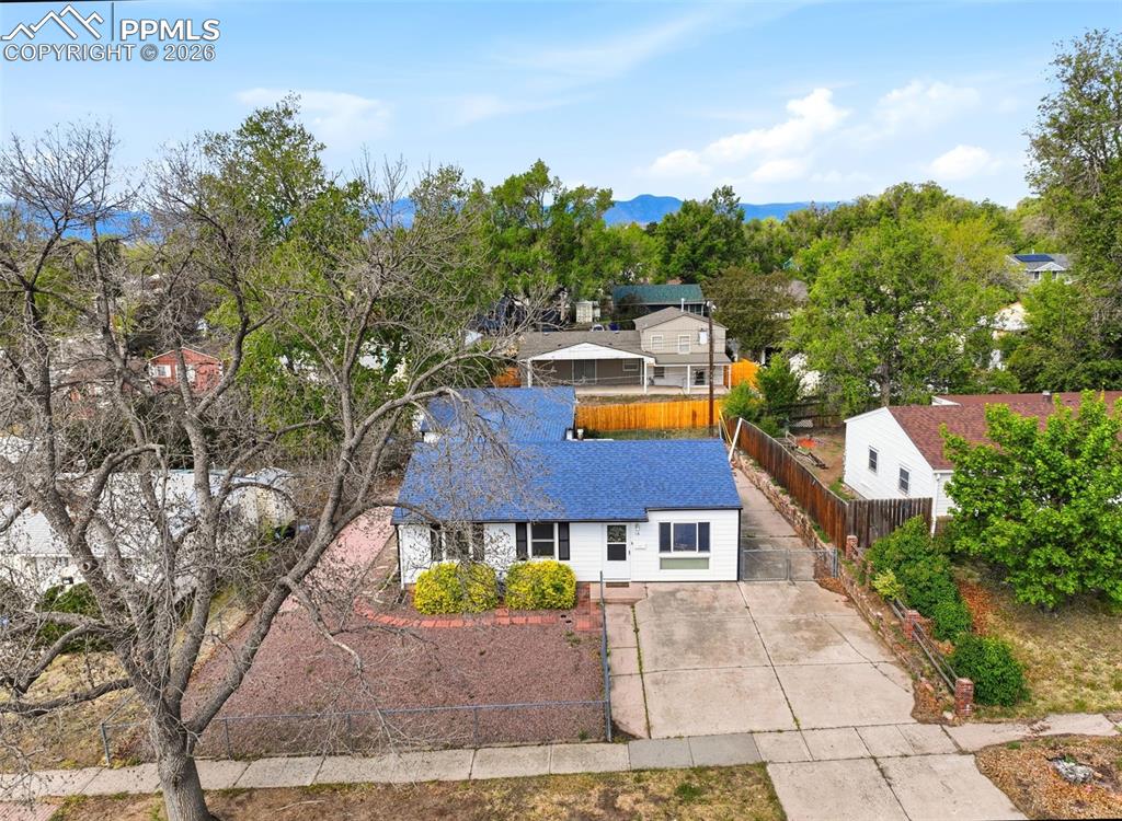 Image 32 of 38: Single-story residence featuring a blue shingle roof and white siding