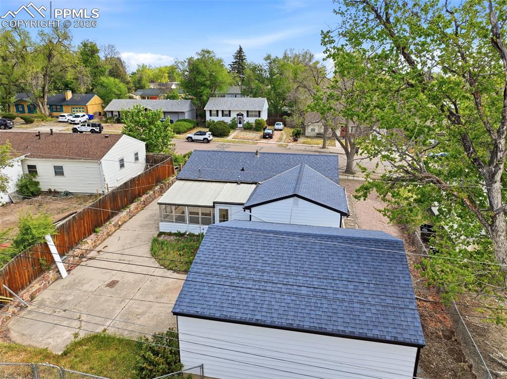 Image 35 of 38: Property featuring light-colored siding and a dark shingle roof