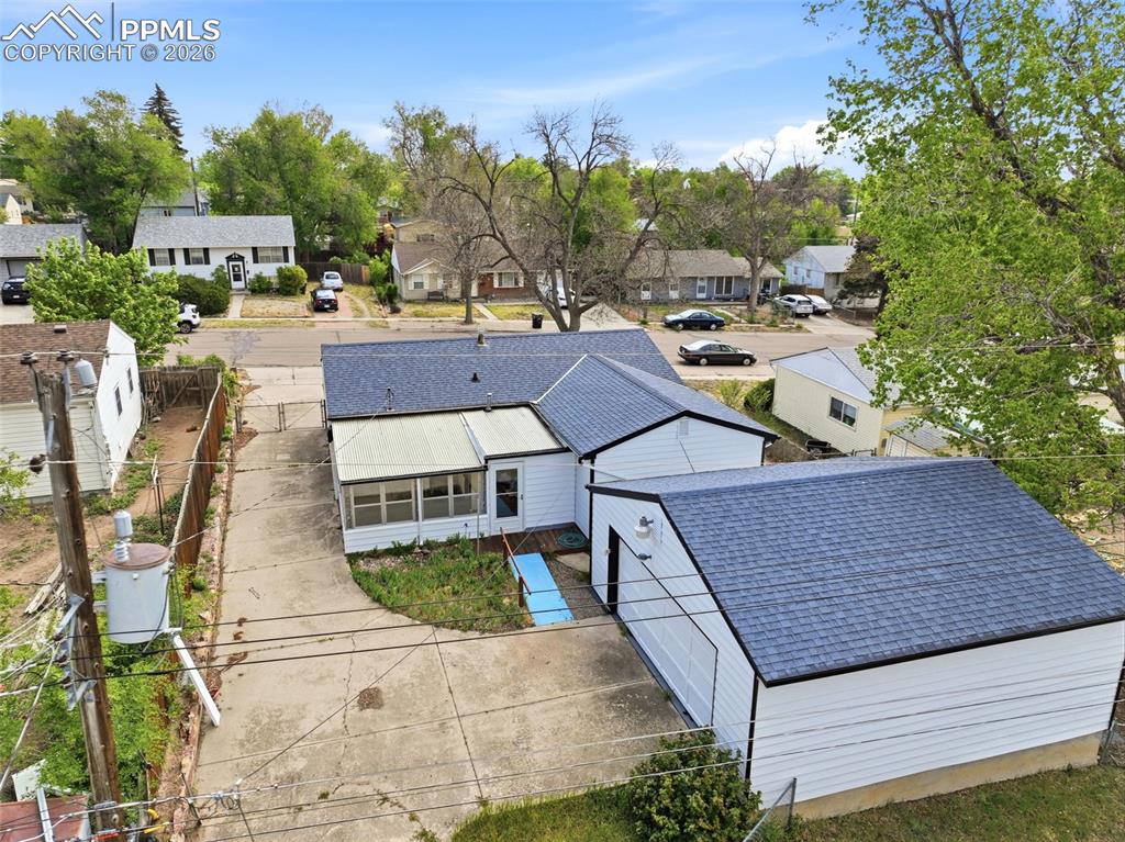 Image 36 of 38: Property featuring white siding, a dark shingle roof, and an attached enclo