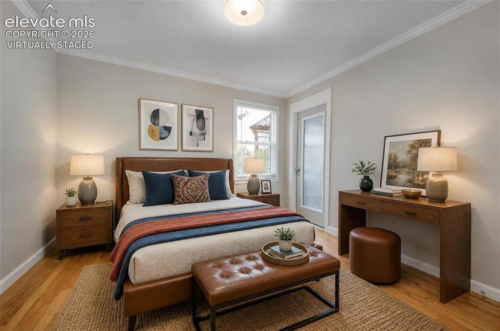 Image 18 of 50: Virtually staged 2nd bedroom upstairs with exit to covered patio