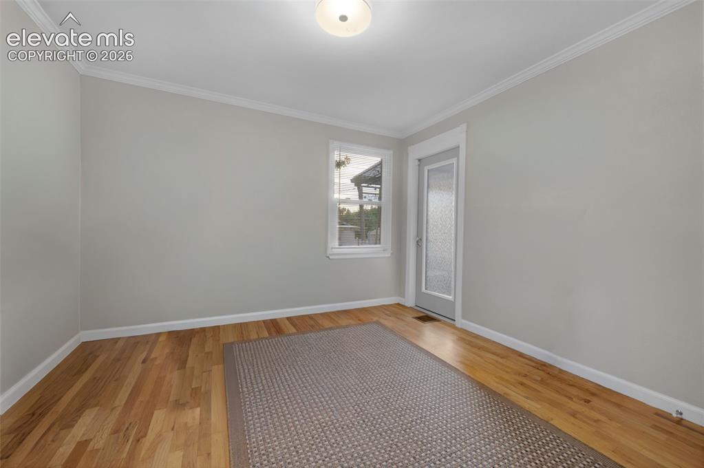 Image 19 of 50: 2nd bedroom upstairs with door to covered patio 