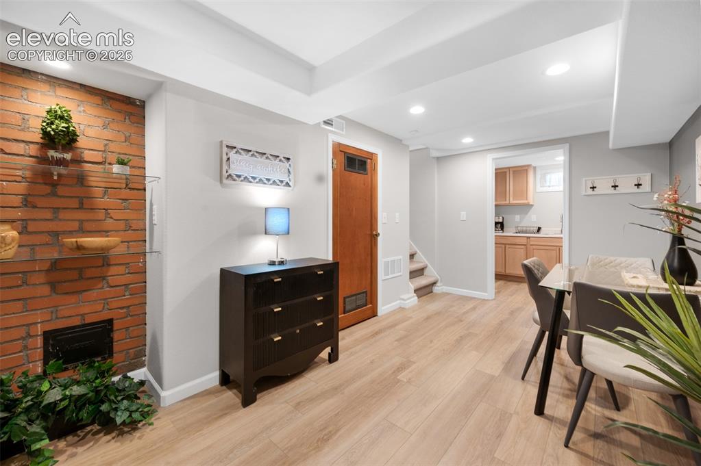 Image 20 of 50: Central area of basement with dining area