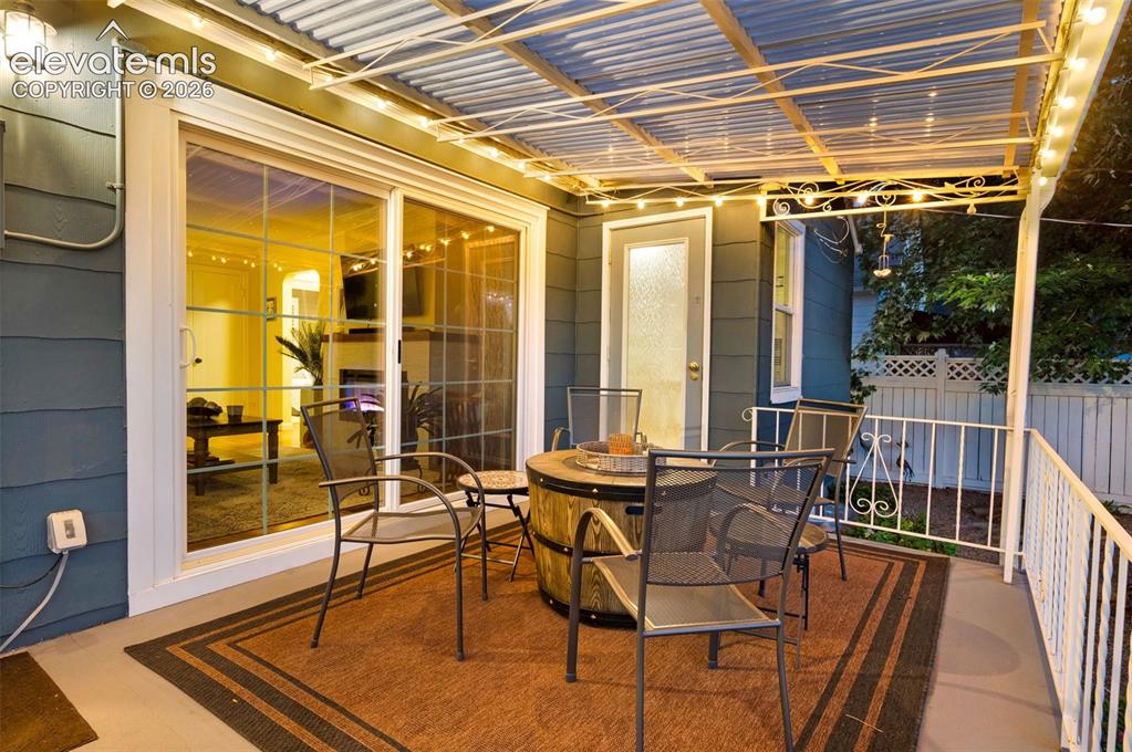Image 31 of 50: back covered patio with walkout from living room