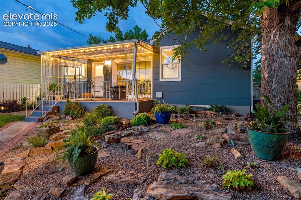 Image 46 of 50: back covered patio, nice landscaping