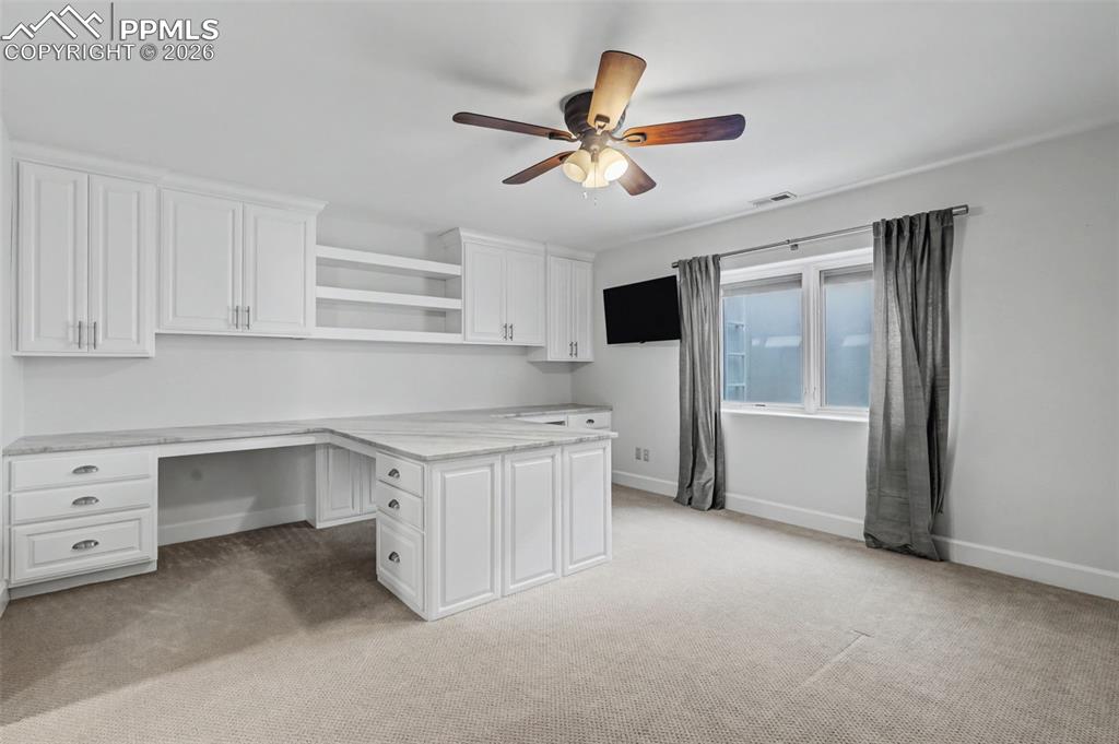 Image 37 of 49: Bedroom has a Murphy bed and custom built office space