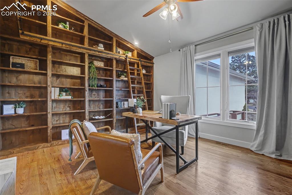 Image 6 of 49: Custom built library with rolling ladder