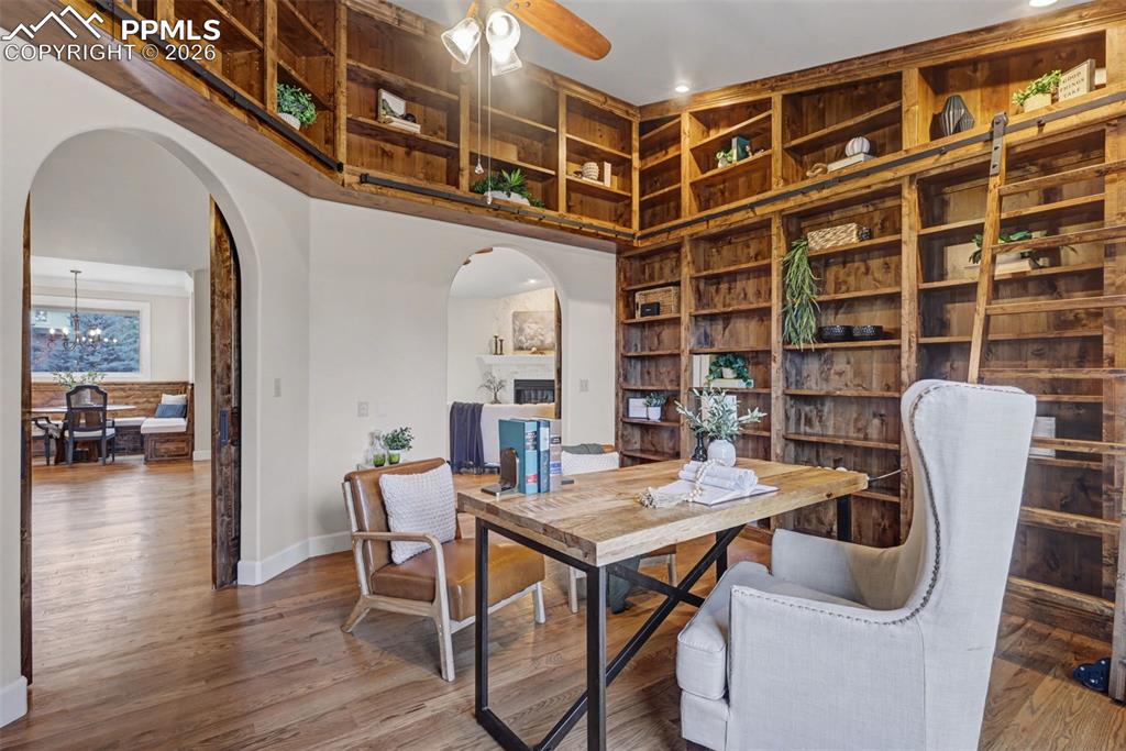 Image 7 of 49: Custom built library with rolling ladder