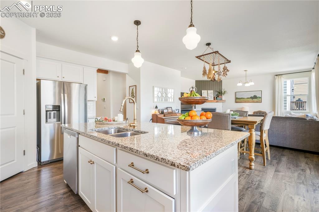 Image 13 of 50: Kitchen with gas range, stainless appliances, walk in pantry, granite count