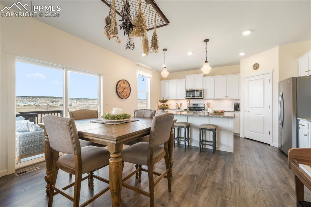 Image 16 of 50: Dining area with access to the back patio