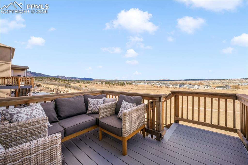 Image 17 of 50: Composite deck with access from dining area and stairs to back yard