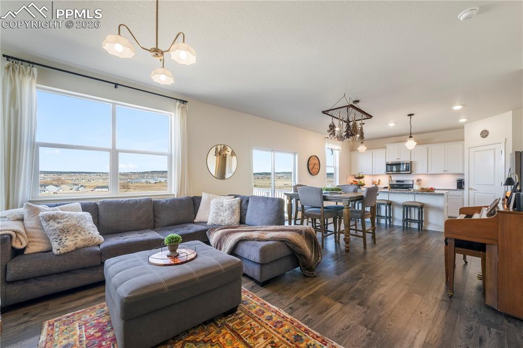 Image 20 of 50: Main level living room with abundant light, gas fireplace