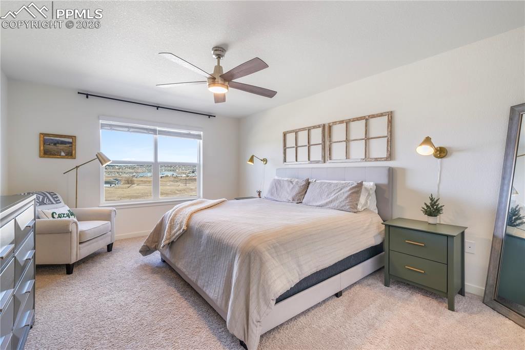 Image 22 of 50: Upstairs primary bedroom with space for seating area, ensuite bathroom and 