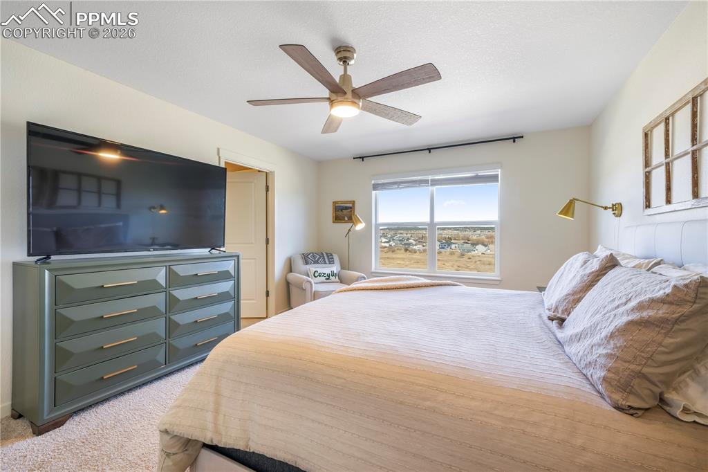 Image 23 of 50: Upstairs primary bedroom with space for seating area, ensuite bathroom and 