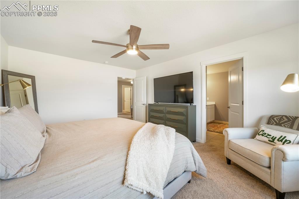 Image 24 of 50: Upstairs primary bedroom with space for seating area, ensuite bathroom and 