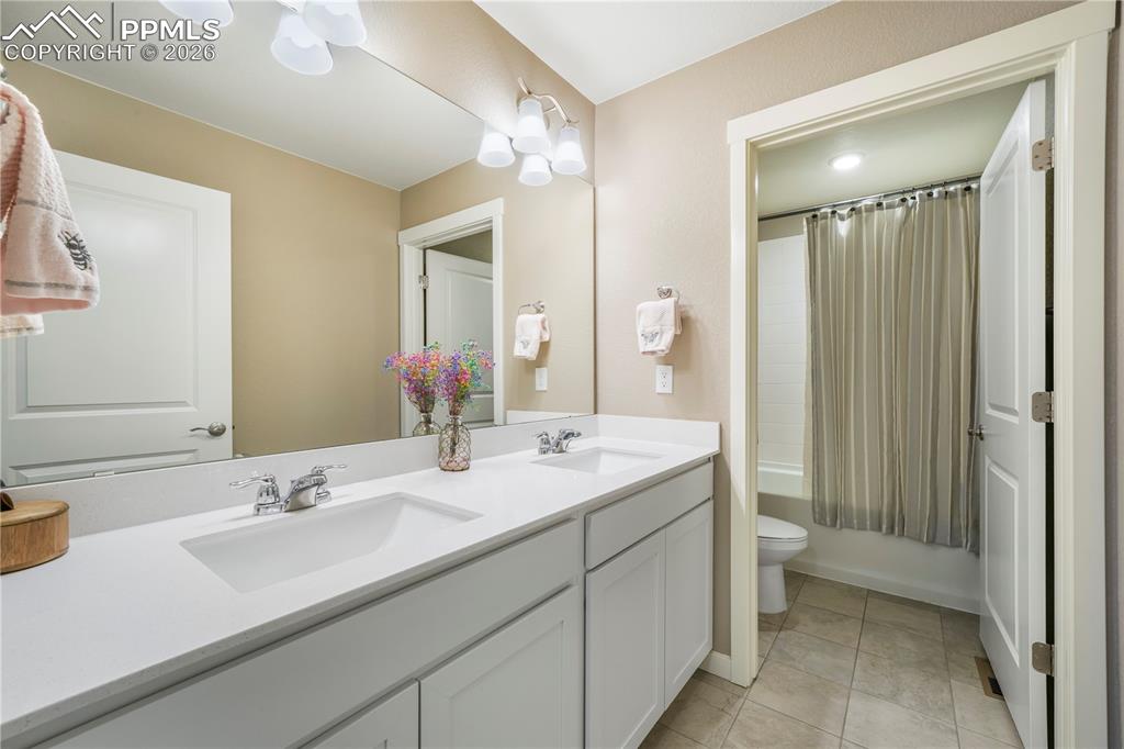 Image 32 of 50: Upstairs full bathroom with quartz counters