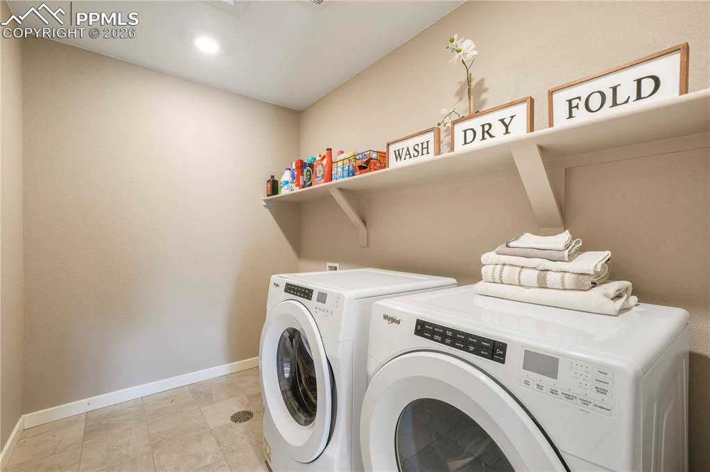 Image 34 of 50: Upstairs laundry area with tile floors