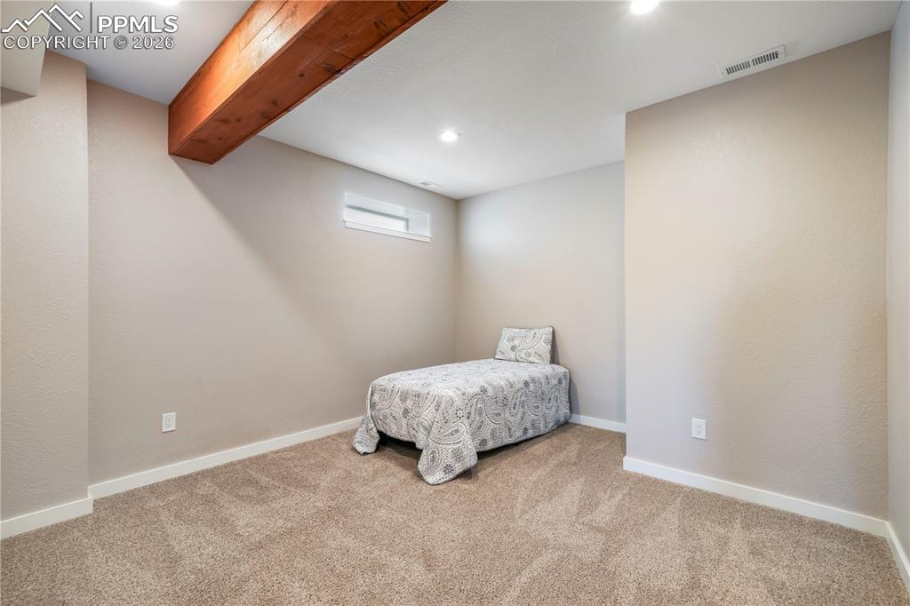 Image 43 of 50: Basement level flex room - great for guests, workout room, media room, ect