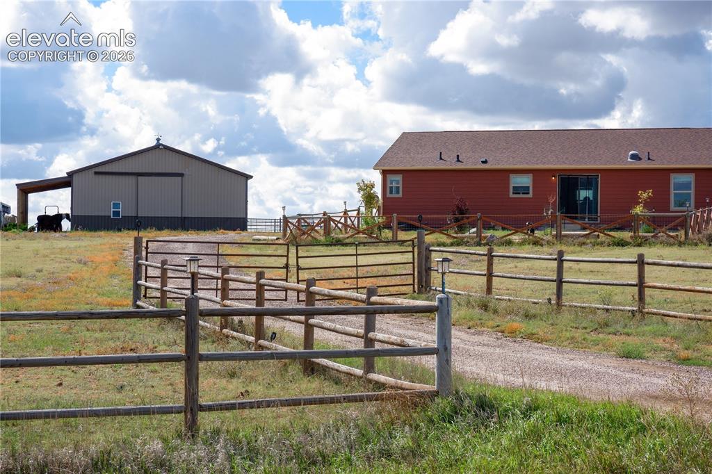 Caption: gated entrance, barn, and home
