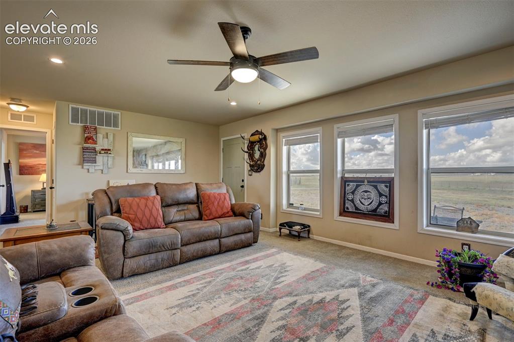 Image 12 of 50: Recessed lighting, ceiling fan with integrated lighting, multiple windows,