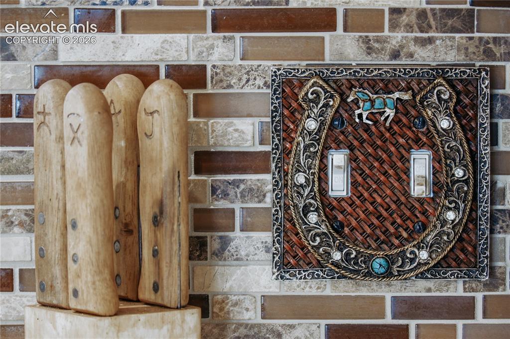 Image 18 of 50: stylish finishes, kitchen backsplash and outlet covers