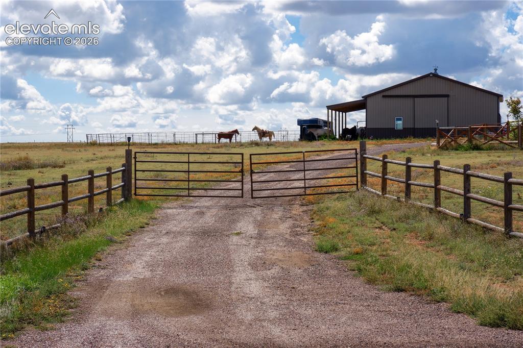 Image 2 of 50: gated entrance, round pen, barn