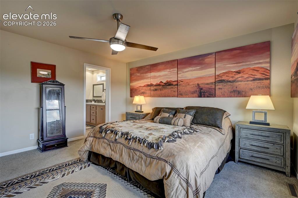 Image 25 of 50: Carpeted room with a ceiling fan, recessed lighting, and an entryway to an