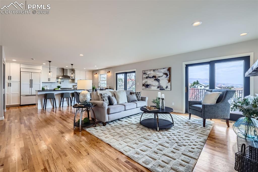 Image 4 of 34: Living area featuring baseboards, recessed lighting, light wood-style floor