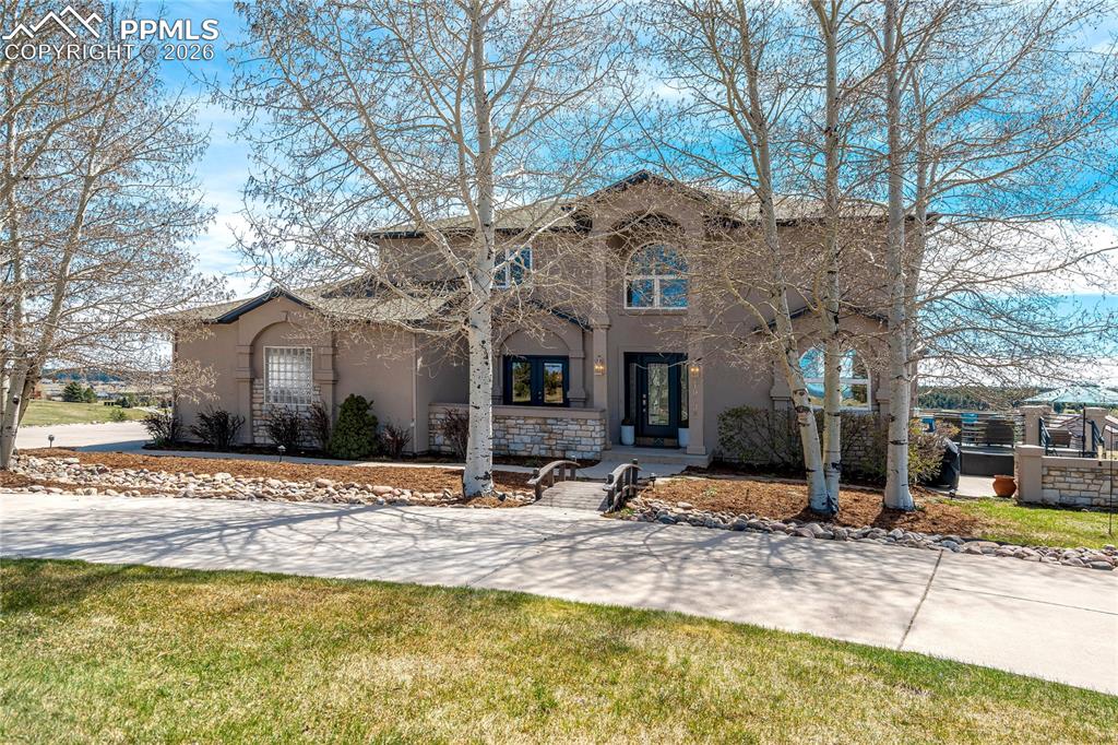 Image 1 of 50: Set on 2.53 acres within Kings Deer, this property captures Pikes Peak view