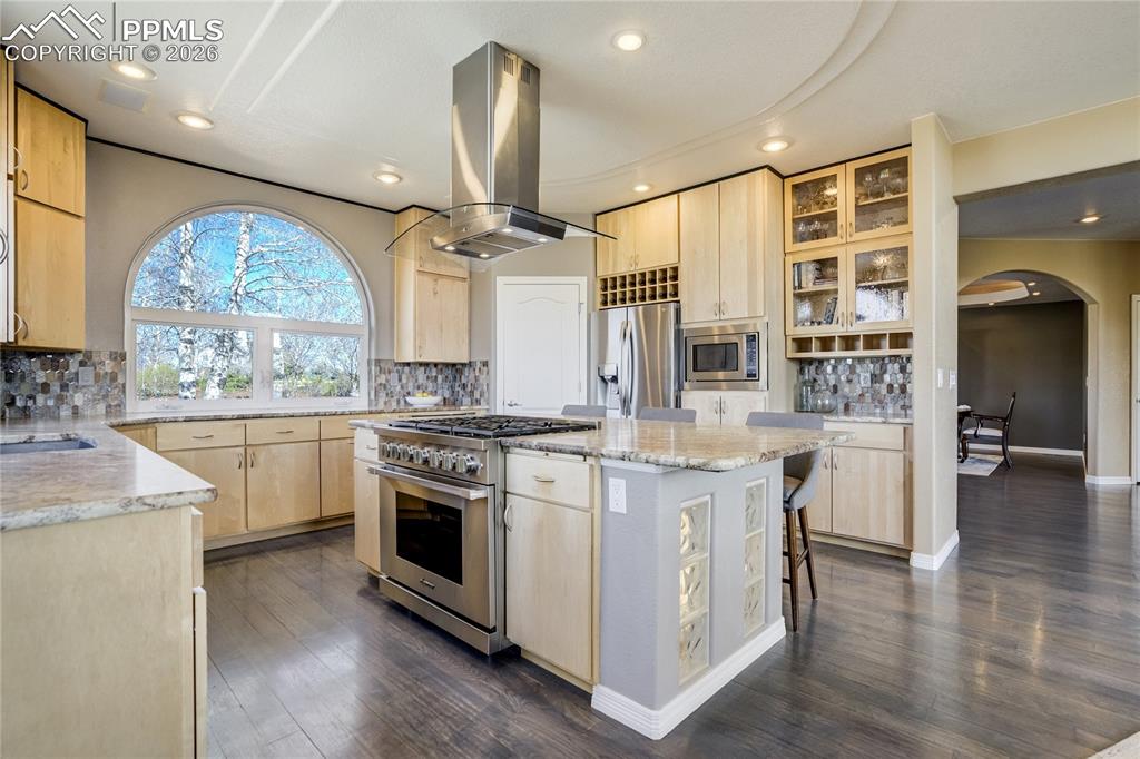 Image 20 of 50: The kitchen is both refined and highly functional, featuring maple cabinetr