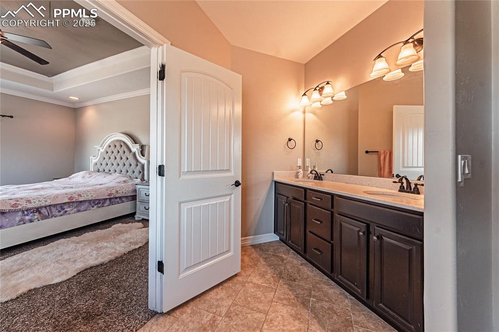 Image 12 of 36: Ensuite bathroom featuring crown molding, a tray ceiling, ensuite bath, a c