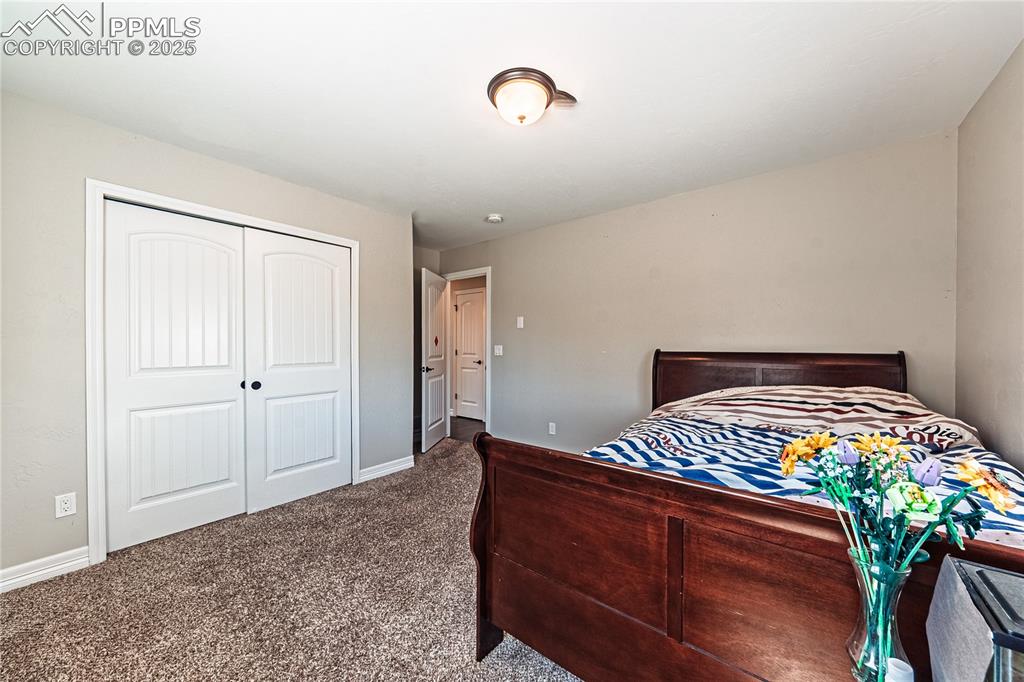 Image 17 of 36: Carpeted bedroom with baseboards and a closet