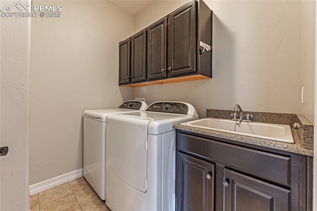 Image 19 of 36: Clothes washing area featuring a sink, baseboards, light tile patterned flo