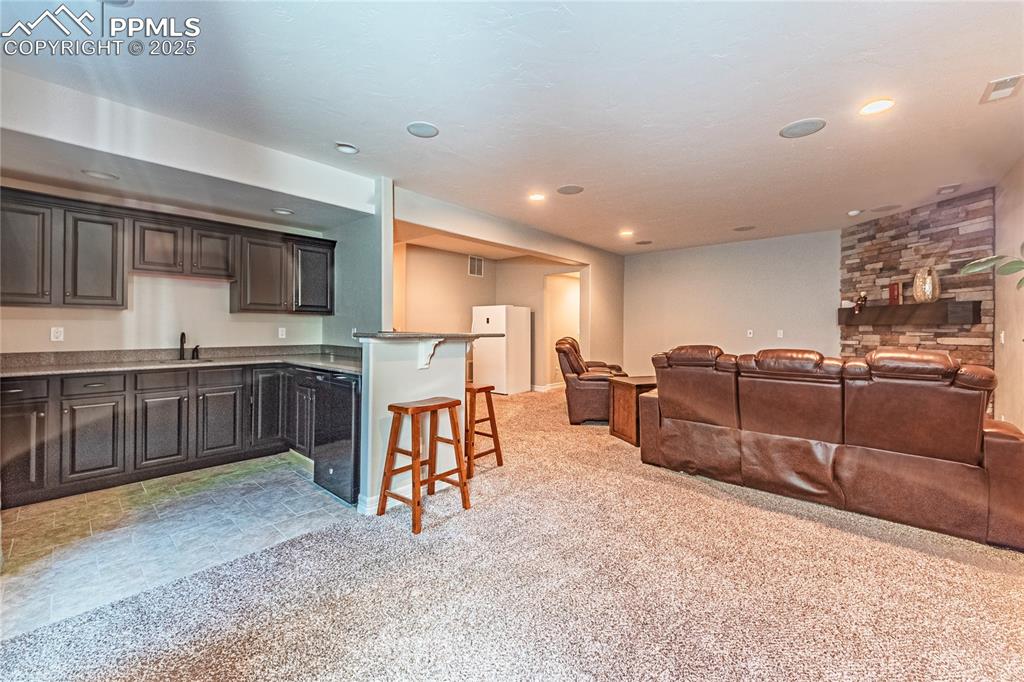 Image 23 of 36: Living room featuring recessed lighting, visible vents, light carpet, and a