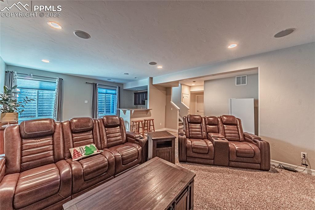 Image 24 of 36: Carpeted home theater featuring recessed lighting, baseboards, and visible